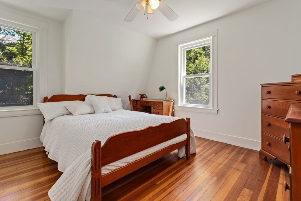 34 Eustis Street Saugus, MA 01906 - Photo 21 of 28 a bedroom with a bed and a chandelier