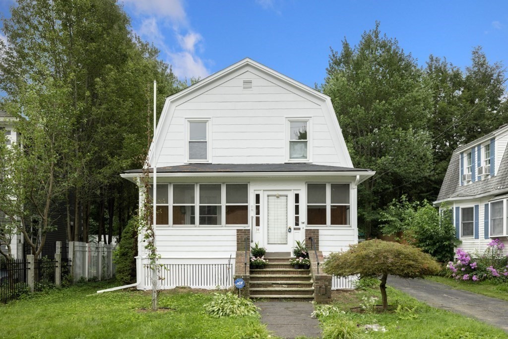 34 Eustis Street Saugus, MA 01906 - Photo 25 of 28 a front view of a house with a yard and trees