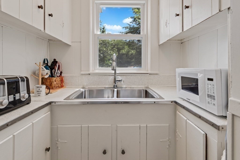 34 Eustis Street Saugus, MA 01906 - Photo 10 of 28 a kitchen with a sink and a stove
