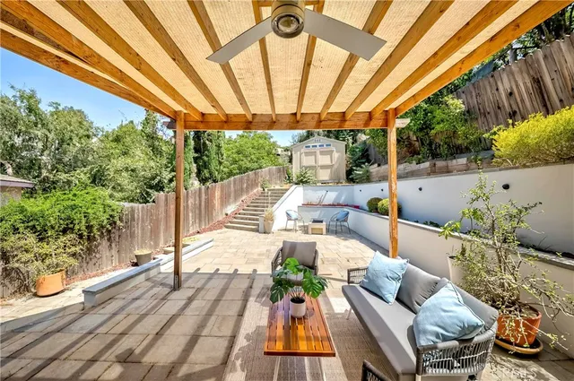 a view of yard from deck with patio