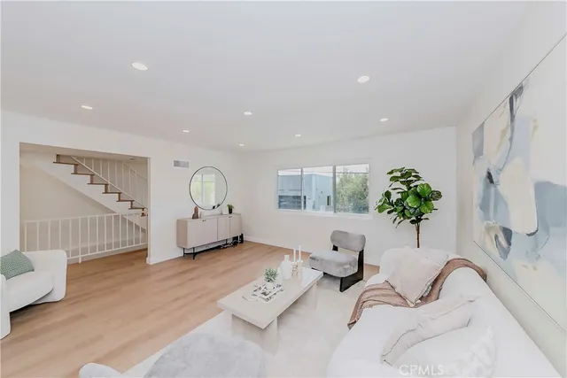 a view of a hallway with wooden floor and dining room