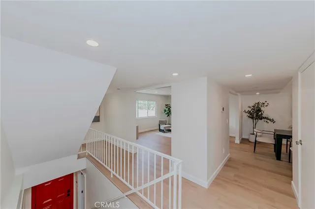 a bedroom with a bed a mirror and a window