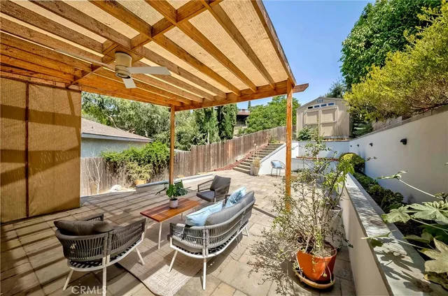 a view of a patio with table and chairs and wooden floor
