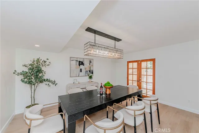 a view of a dining room with furniture and chandelier