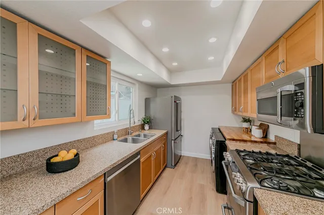 a kitchen with sink stove and cabinets