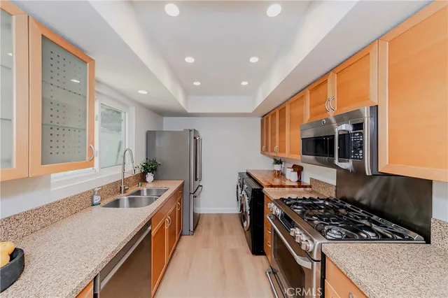 a kitchen with a stove a sink and a refrigerator