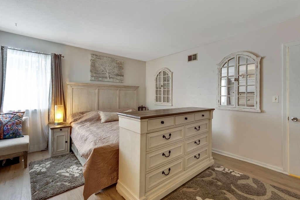 15 Conestoga Road Lexington, MA 02421 - Photo 12 of 31 a bedroom with a bed and a dresser