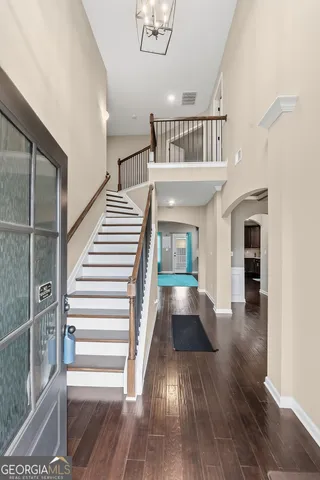 a view of entryway and hall with wooden floor