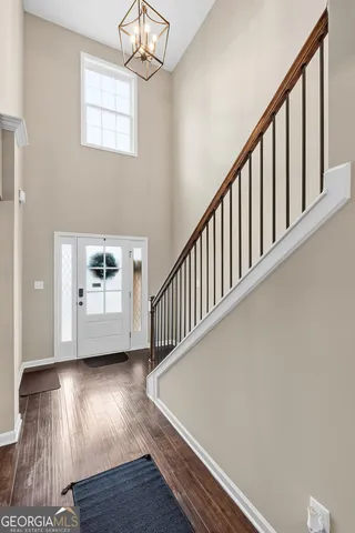 a view of a dining room with furniture wooden floor and chandelier
