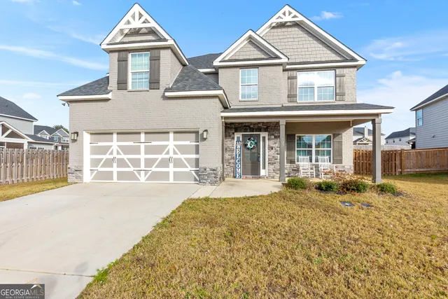 a front view of a house with a yard and garage