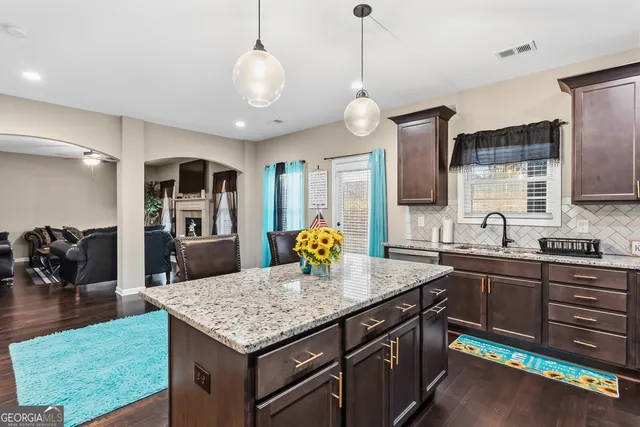 a bedroom with a bed a dresser and flat screen tv