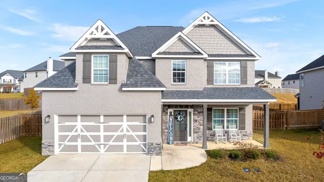 a front view of a house with a yard and garage
