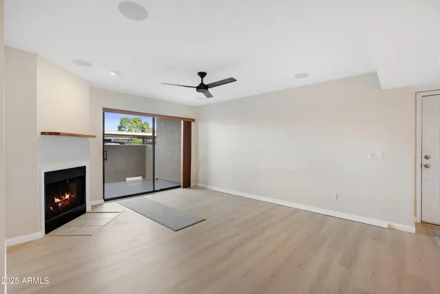 a view of empty room with a fireplace and window