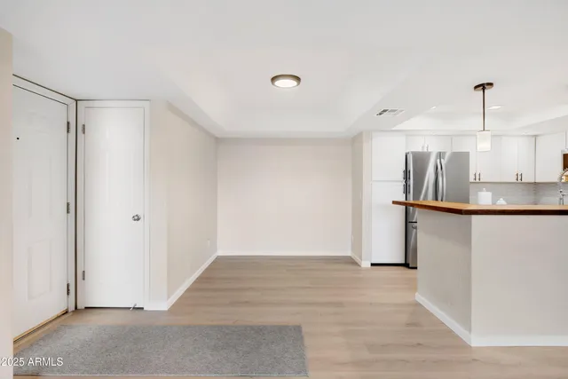 a view of a kitchen with a sink and a refrigerator
