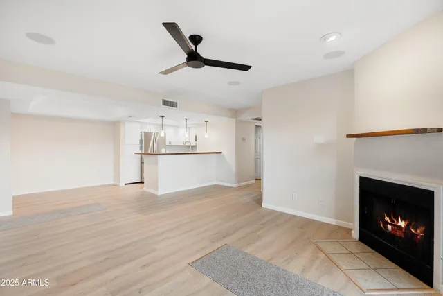 a view of a kitchen with a fireplace and windows