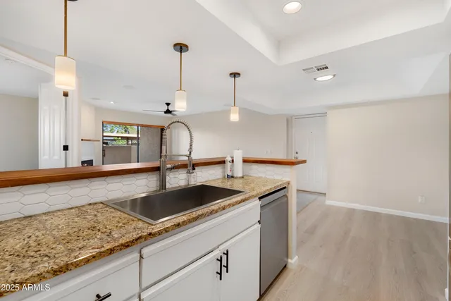 a kitchen with a sink and refrigerator