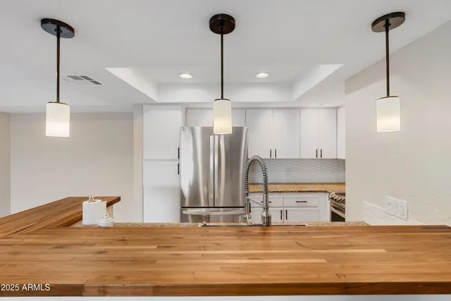 a view of a kitchen with a sink and cabinets