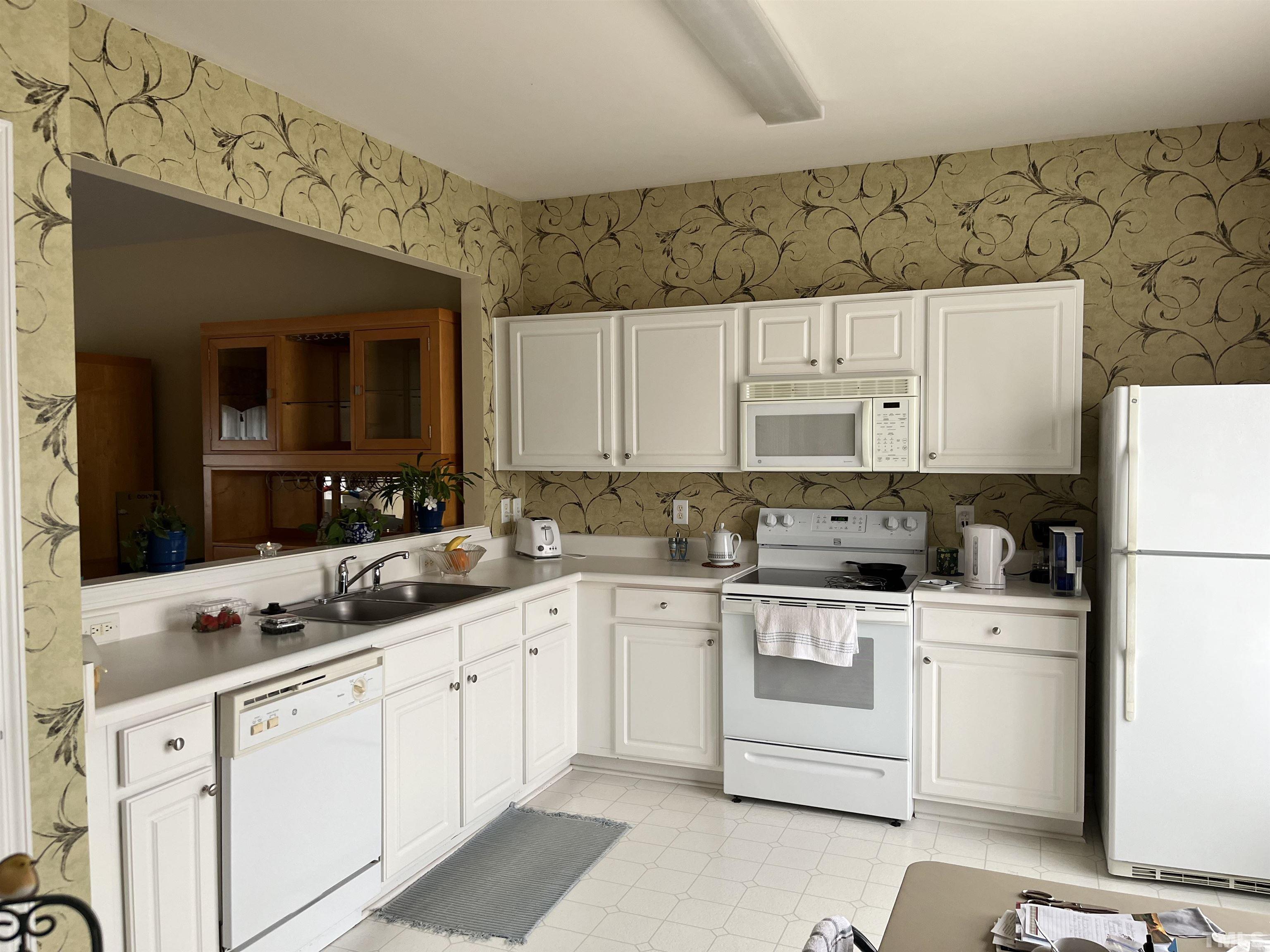 5309 Glen Canyon Road Raleigh, NC 27616 - Photo 7 of 11 a kitchen with cabinets appliances a sink and a counter top