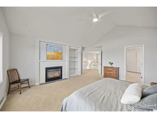 a bedroom with a bed and a fireplace