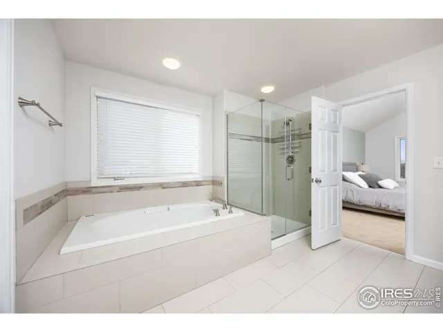 a bathroom with a tub a sink and a shower