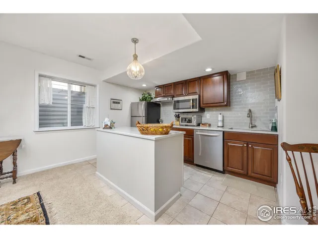 a living room with furniture a rug and a dining table