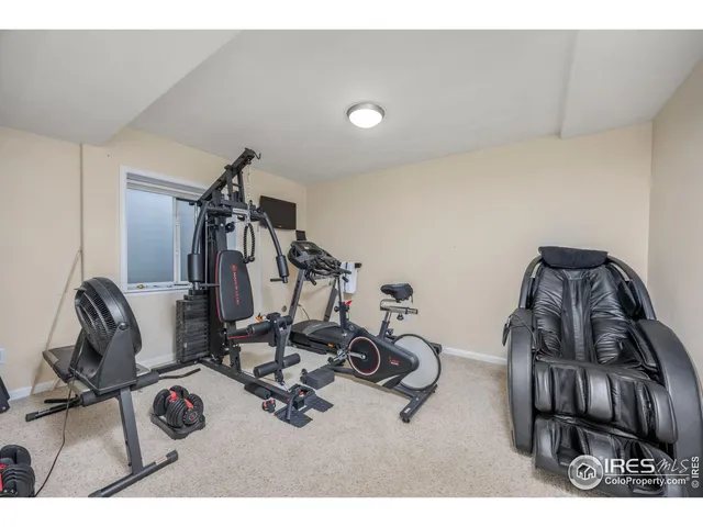 a balcony with wooden floor table and chairs
