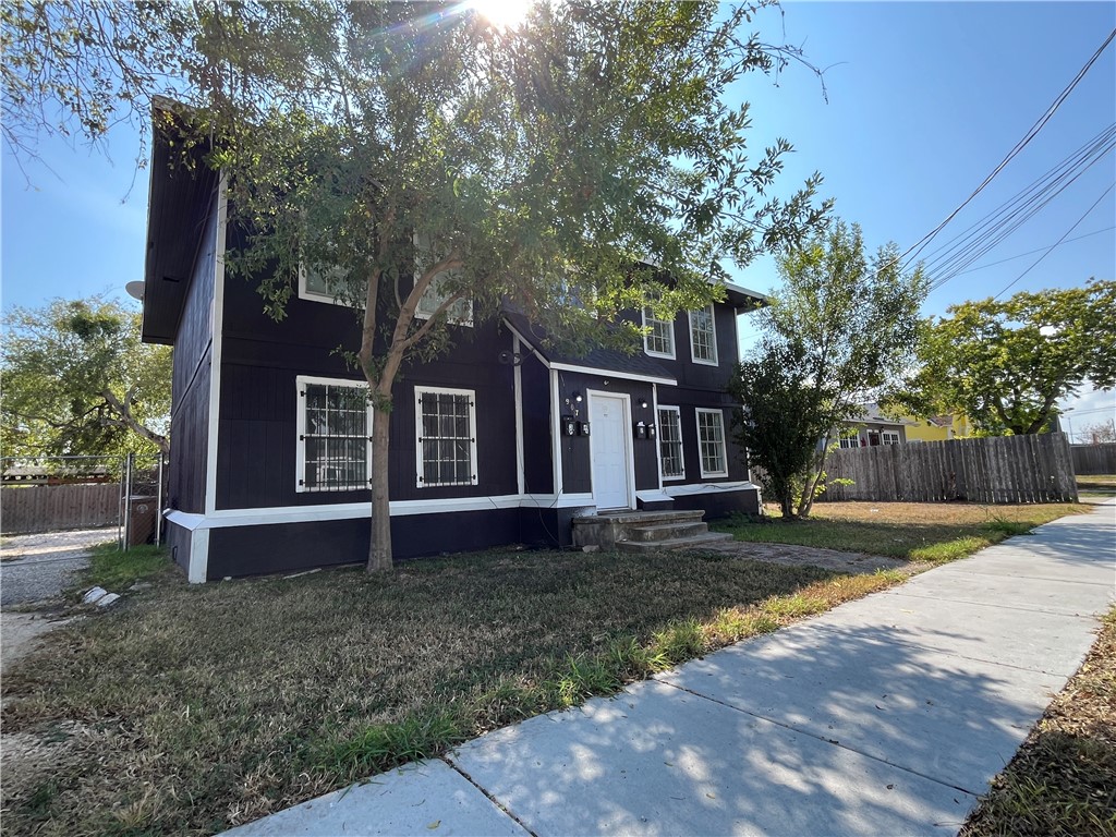 a house that has tree in front of it