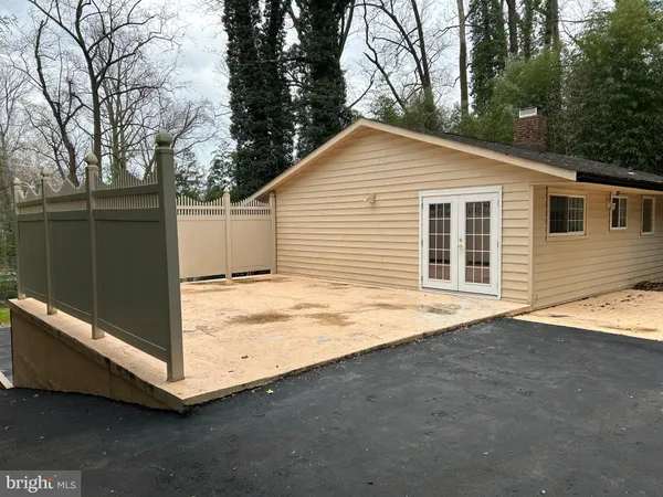 a backyard of a house with wooden fence