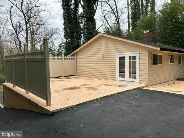 a backyard of a house with wooden fence