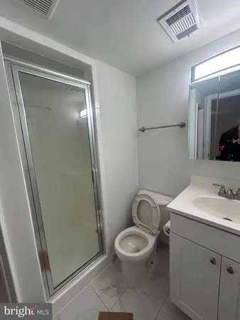 a bathroom with a toilet a sink and a mirror