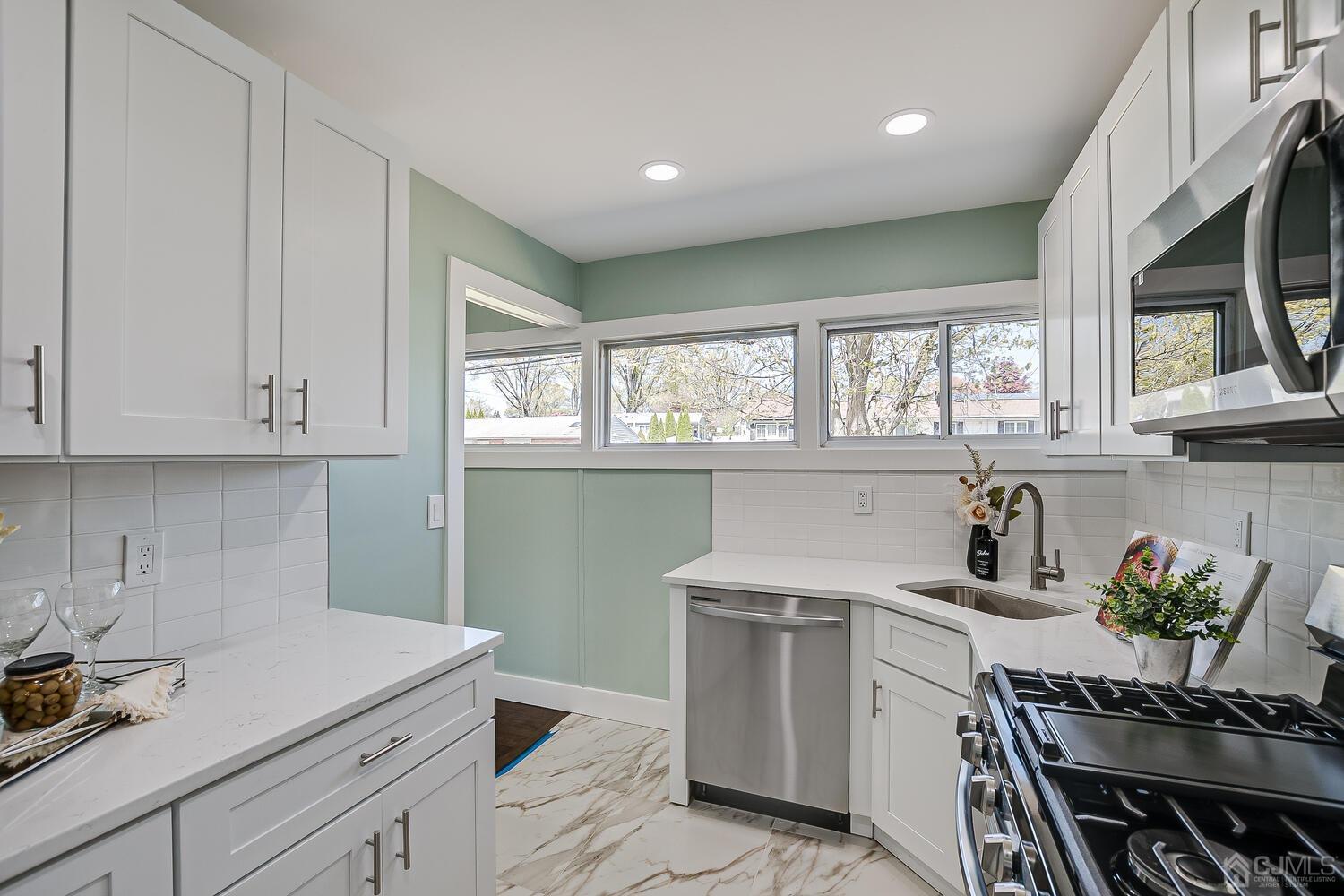 16 Fordham Road Old Bridge, NJ 08859 - Photo 13 of 33 a kitchen with a white cabinets and window