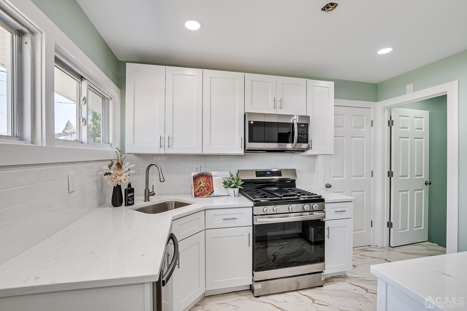 16 Fordham Road Old Bridge, NJ 08859 - Photo 10 of 33 a kitchen with white cabinets and appliances