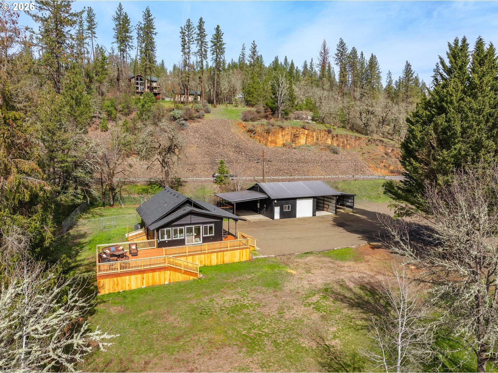 24990 Highway 62 Trail, OR 97541 - Photo 1 of 23 an aerial view of a house with swimming pool and mountains