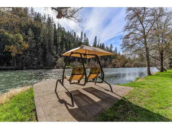 a view of a patio with a table and chairs under an umbrella