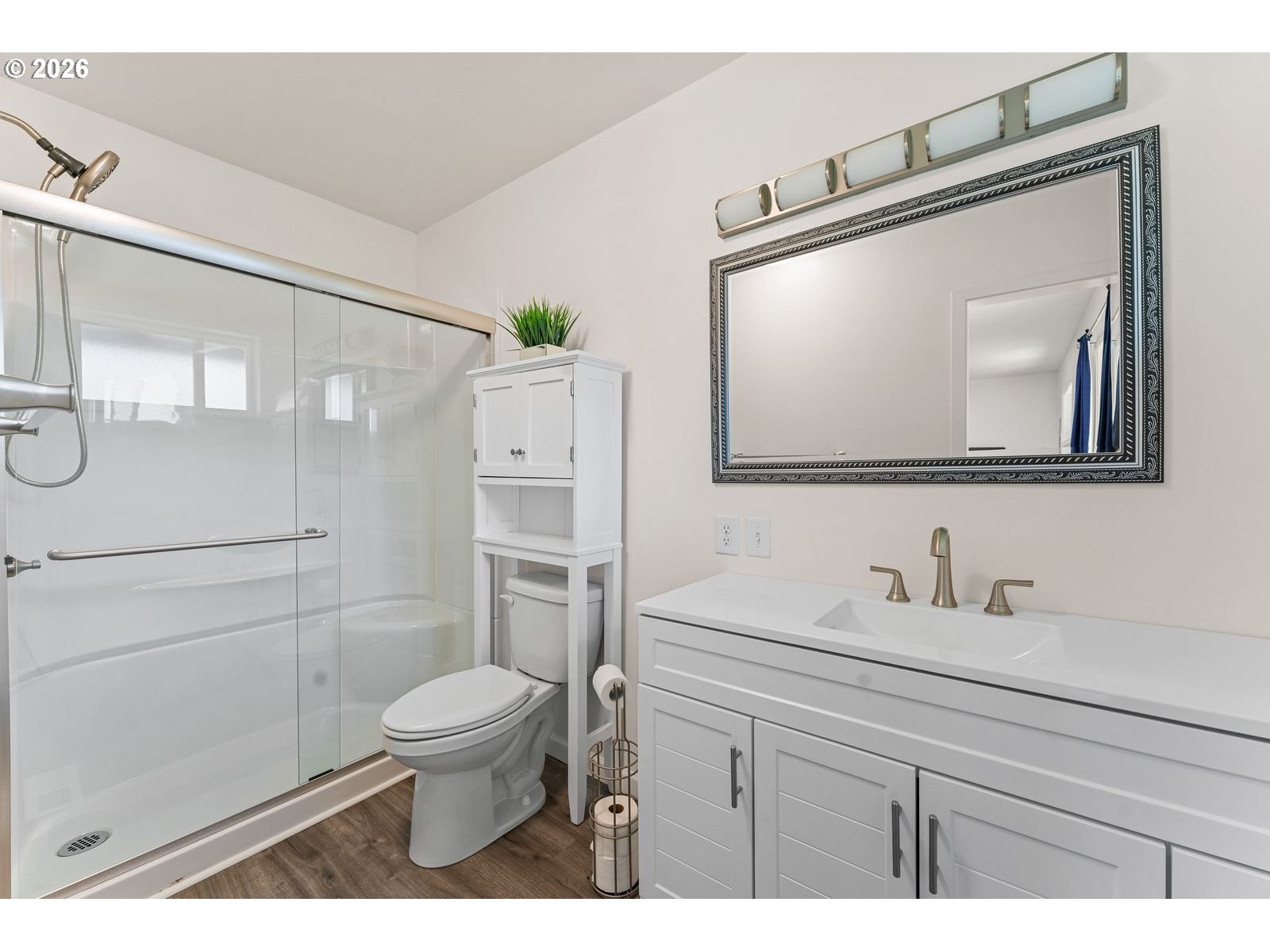 24990 Highway 62 Trail, OR 97541 - Photo 17 of 23 a bathroom with a toilet a sink a glass door a shower and a mirror