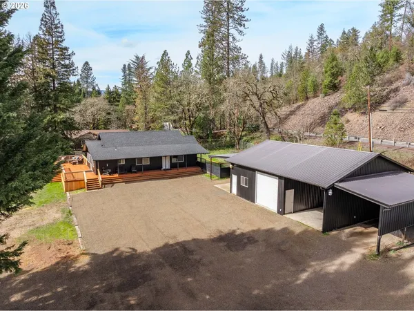 a view of a house with a yard and sitting area