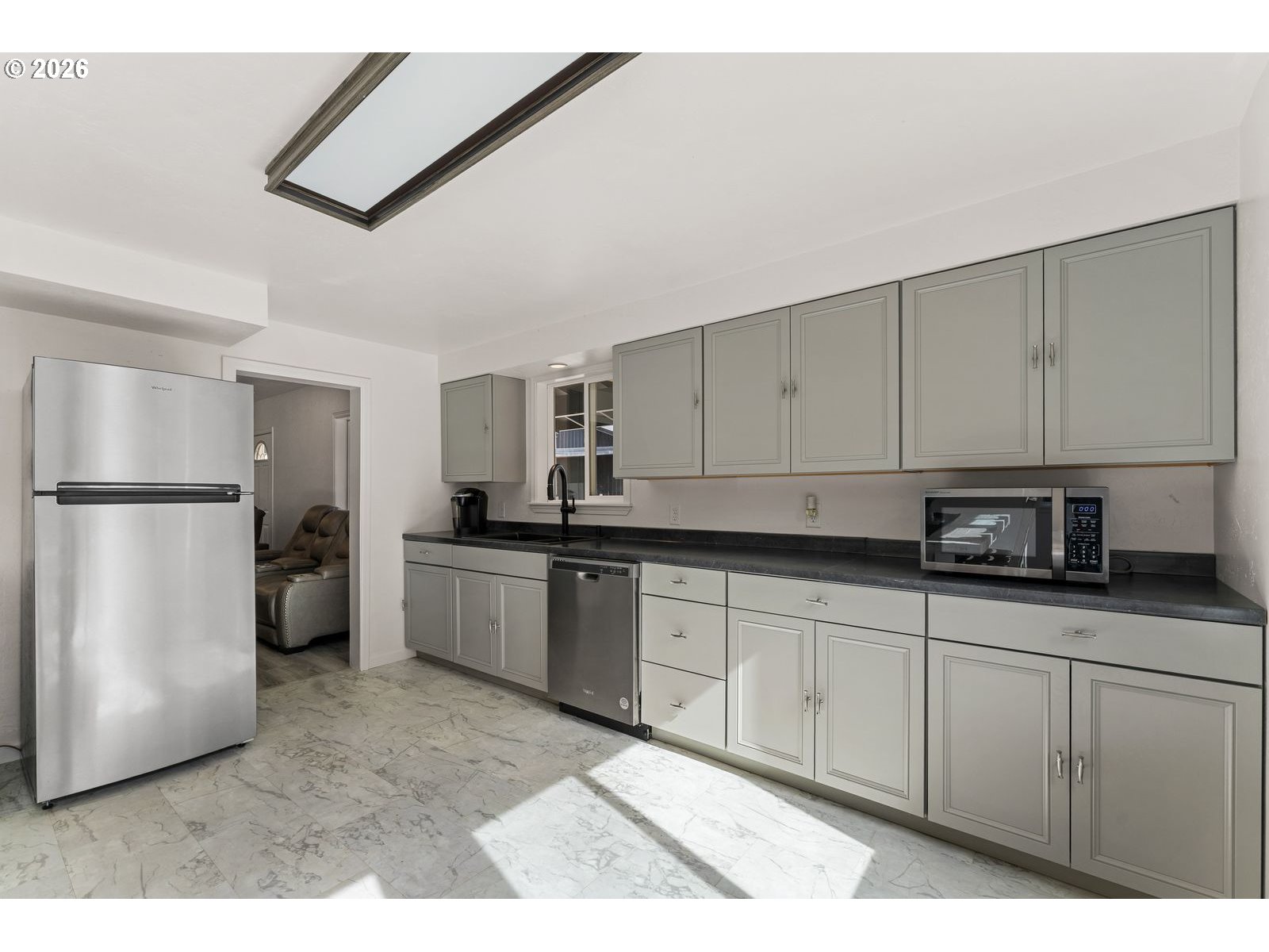24990 Highway 62 Trail, OR 97541 - Photo 9 of 23 a kitchen with stainless steel appliances granite countertop a refrigerator sink and white cabinets