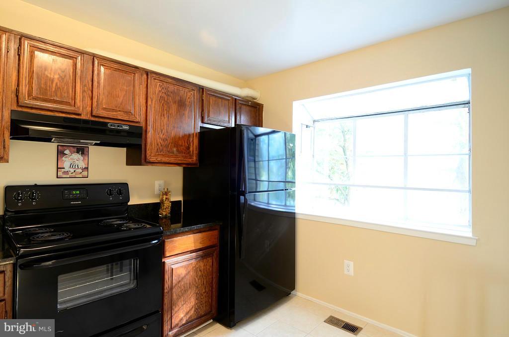 2330 Hunters Square Court Reston, VA 20191 - Photo 11 of 30 a kitchen with a refrigerator and a stove