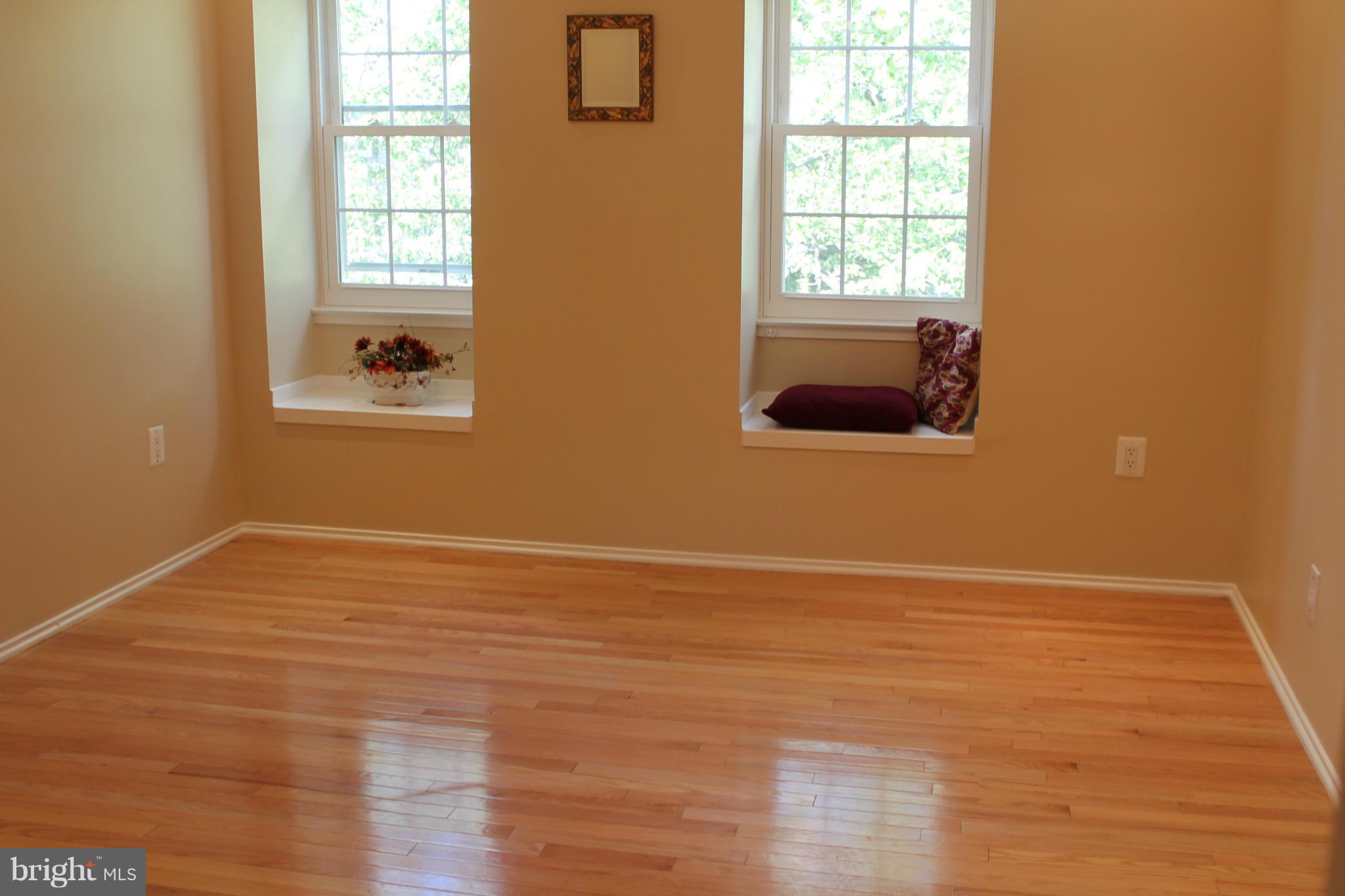 2330 Hunters Square Court Reston, VA 20191 - Photo 15 of 30 a view of an empty room with wooden floor and a window