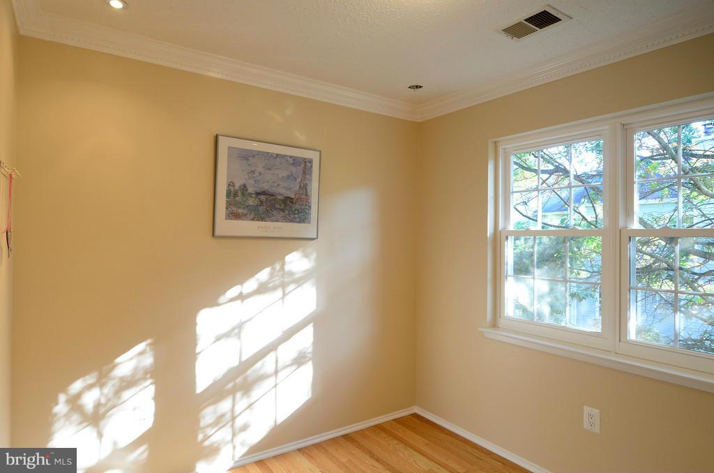 2330 Hunters Square Court Reston, VA 20191 - Photo 20 of 30 a view of a bedroom with wooden floor and a window