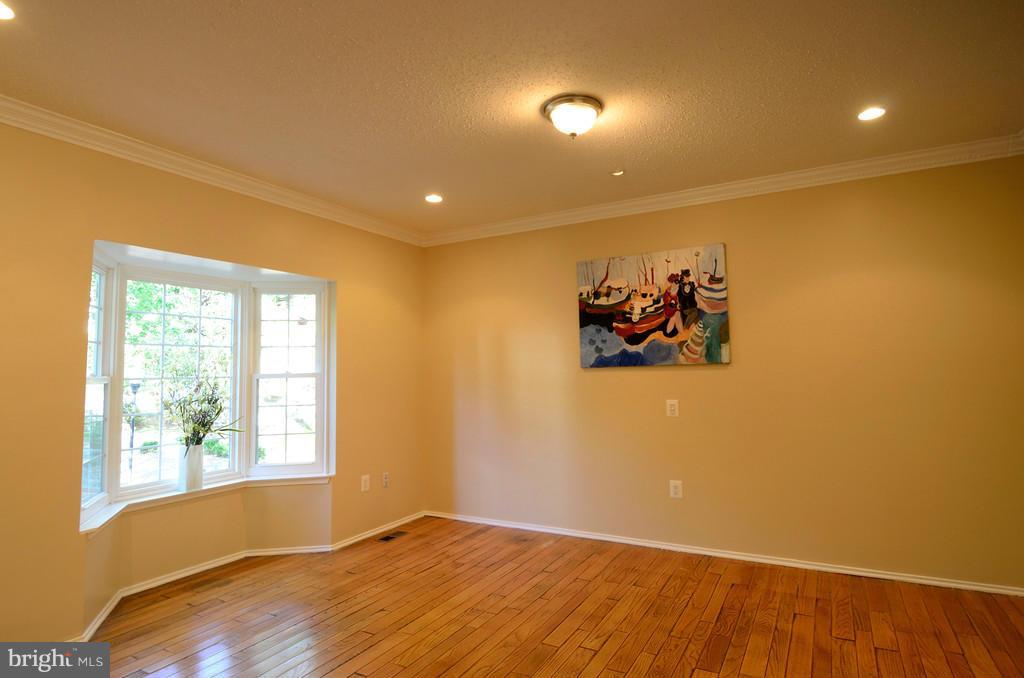 2330 Hunters Square Court Reston, VA 20191 - Photo 3 of 30 a view of a big room with wooden floor and windows