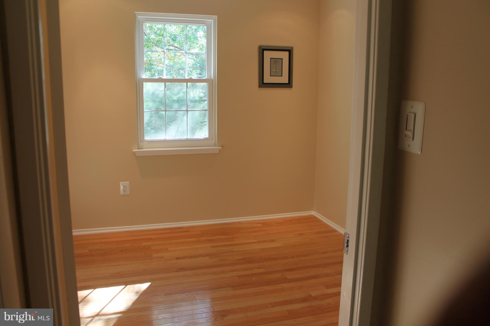2330 Hunters Square Court Reston, VA 20191 - Photo 22 of 30 a view of an empty room with wooden floor and a window
