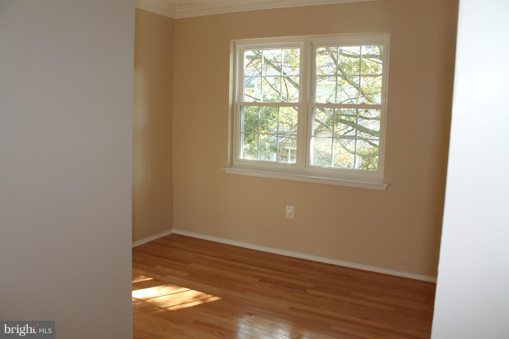 2330 Hunters Square Court Reston, VA 20191 - Photo 23 of 30 an empty room with wooden floor and windows