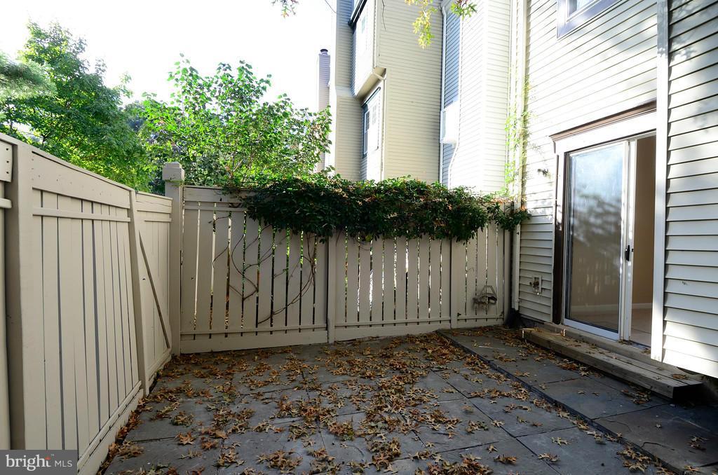 2330 Hunters Square Court Reston, VA 20191 - Photo 30 of 30 a view of a backyard with wooden fence