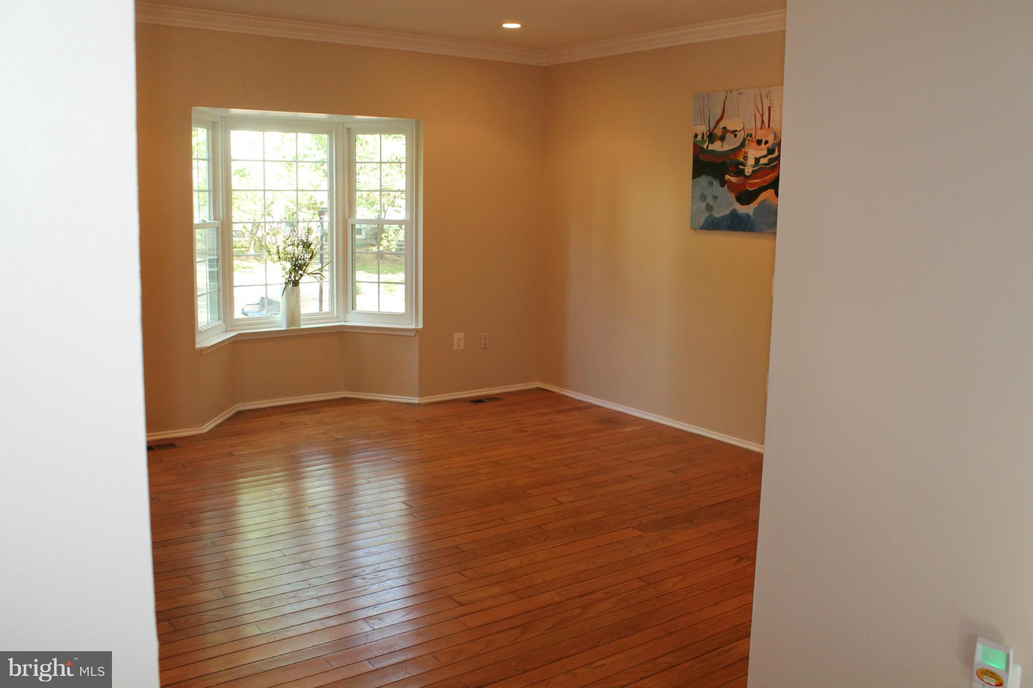 2330 Hunters Square Court Reston, VA 20191 - Photo 5 of 30 a view of empty room with wooden floor and fan