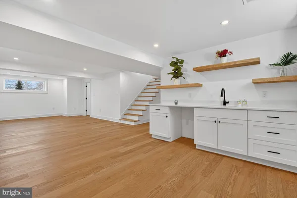 a very nice looking room with wooden floors and natural light