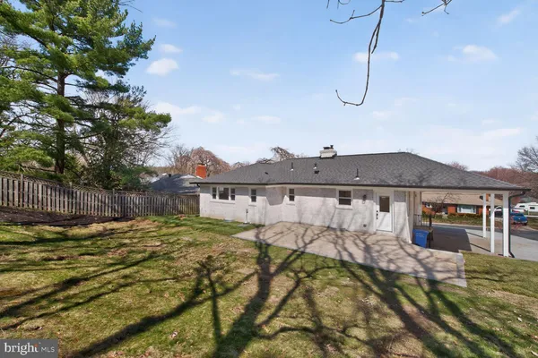 a view of a house with a wooden roof and a yard