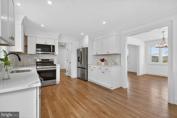 a kitchen with a refrigerator and a stove top oven