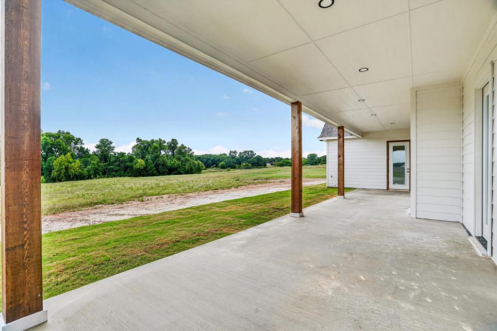 225 Kilkenny Road Poolville, TX 76487 - Photo 33 of 36 Covered concrete patio featuring exposed wood support beams and recessed lighting