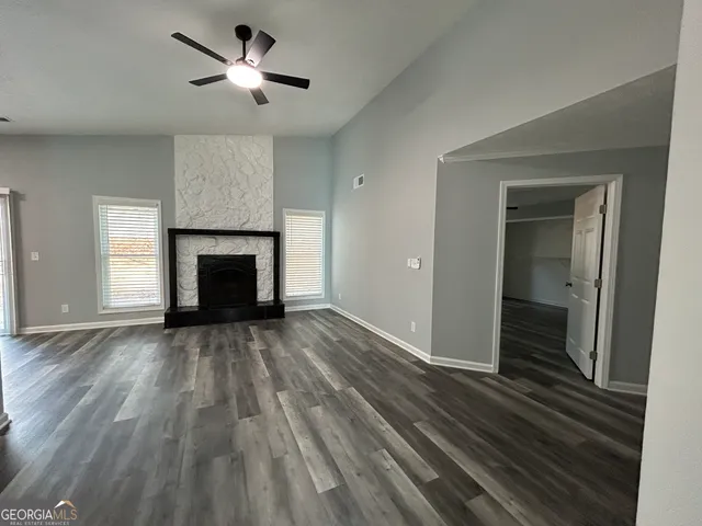 wooden floor in an empty room with a fireplace